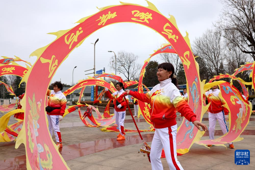 1月18日,在山东省枣庄市西沙河公园,市民在舞“彩龙”庆腊八、迎新春。春节临近,神州大地年味渐浓。新华社发(孙中喆 摄)