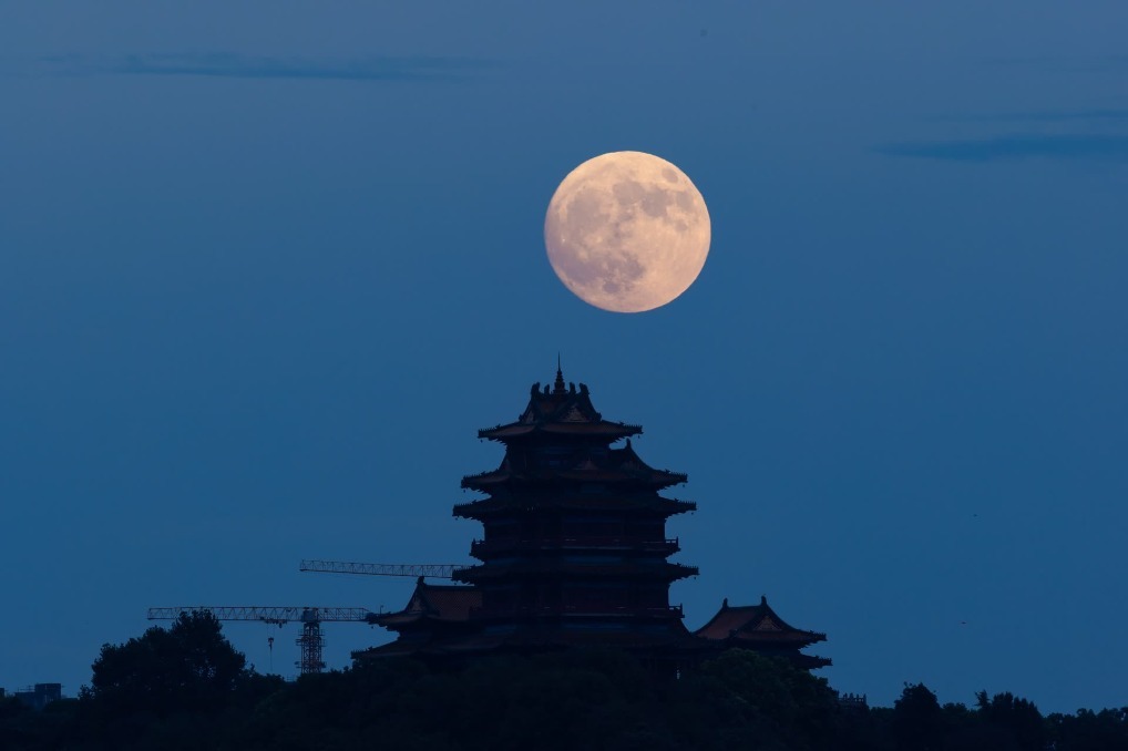 9月17日晚,在南京拍摄的中秋月,阅江楼与月亮相映成景,很多市民来到扬子江生态公园“T台水梦”景点休闲赏月。 新华日报·交汇点记者 蒋文超 摄