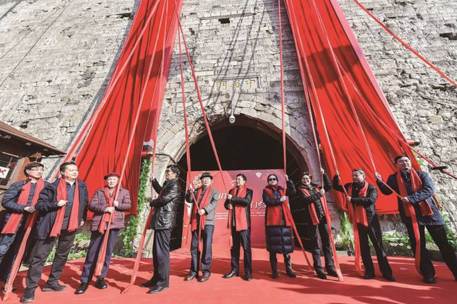 书法家孙晓云(右四)参加"城门挂春联"揭联活动.资料图片