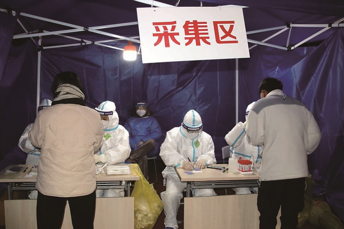 16日晚，苏州市姑苏区双塔街道的居民正在市民健身中心核酸检测站进行核酸采样。 王建康 摄 (视觉江苏网供图)