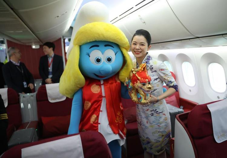 A staff member poses with a smurf costumed character wearing traditional Chinese clothes at the Brussels Airport in Zaventem, Belgium, Feb. 9, 2024. (Xinhua/Zhao Dingzhe)