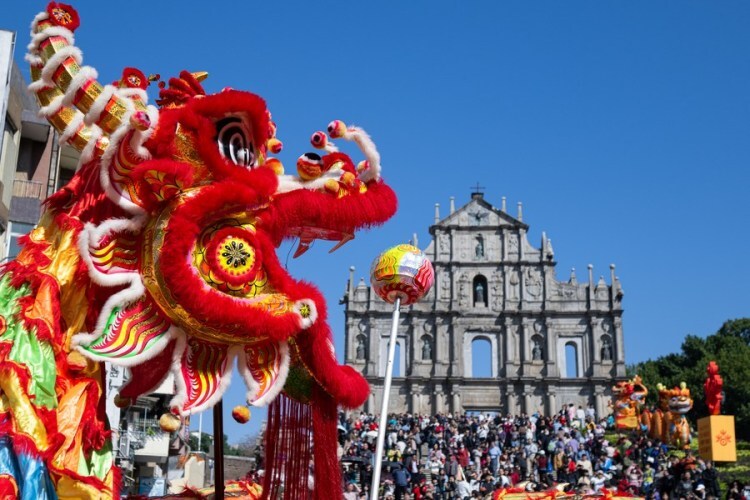 Artists perform lion dances to celebrate the Chinese Lunar New Year in front of the Ruins of St. Paul's in south China's Macao on Feb. 11, 2024. (Xinhua/Cheong Kam Ka)