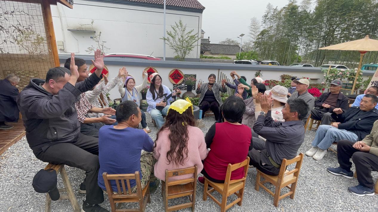 看到,"美丽工坊"小院外,残疾朋友和志愿者正用心勾画着墙面,一笔一画