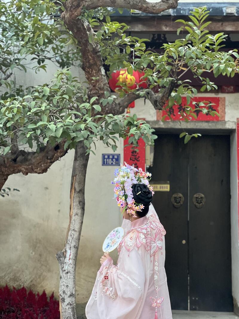 福建泉州,头戴簪花的游客正拍照留念。人民网 欧阳易佳摄