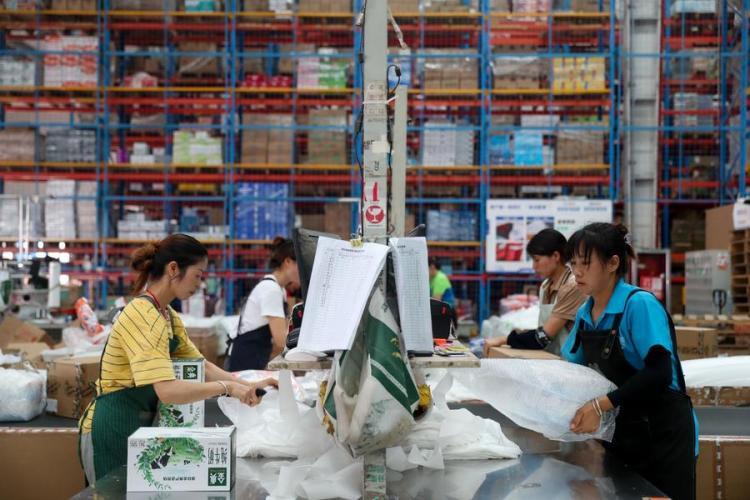 Workers work at a warehouse in Longli County, southwest China's Guizhou Province, June 18, 2024. During the country's mid-year shopping spree, known as the "618" shopping festival, e-commerce and logistics companies, as well as online and offline enterprises, have prepared well to cope with the surging demand. (Photo by Yuan Fuhong/Xinhua)