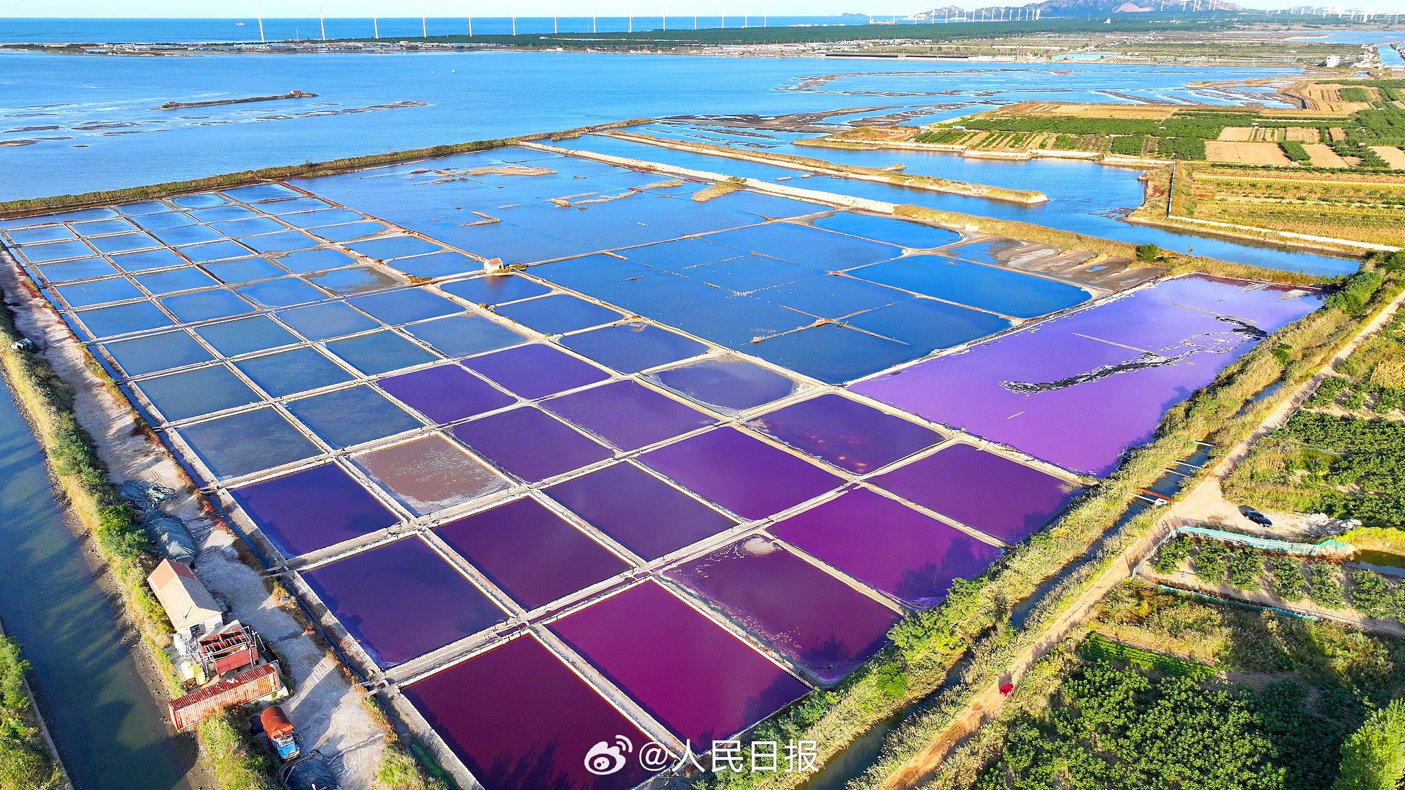 近日，山东荣成，港西镇朝阳港一处盐田，呈现出高饱和度色彩，像是被大自然打翻的调色盘，又如同神秘的大地呈现的一片艺术画布，形成了一道靓丽的风景线。