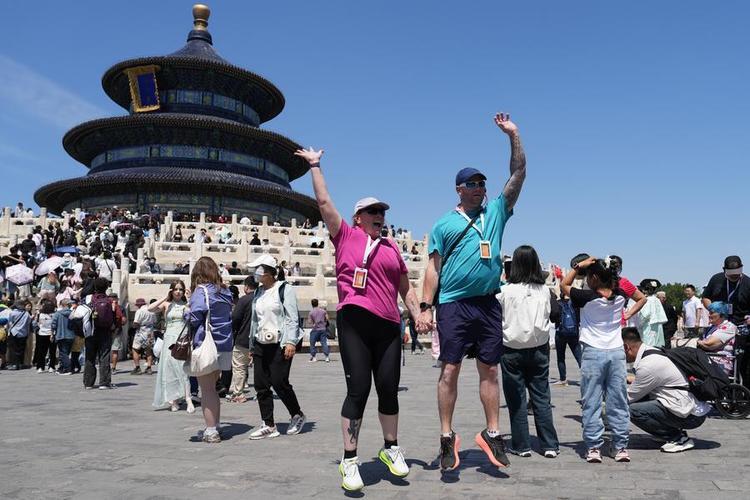 Tourists from Australia pose for photos at the Tiantan (Temple of Heaven) Park in Beijing, capital of China, May 1, 2025. (Xinhua/Ju Huanzong)