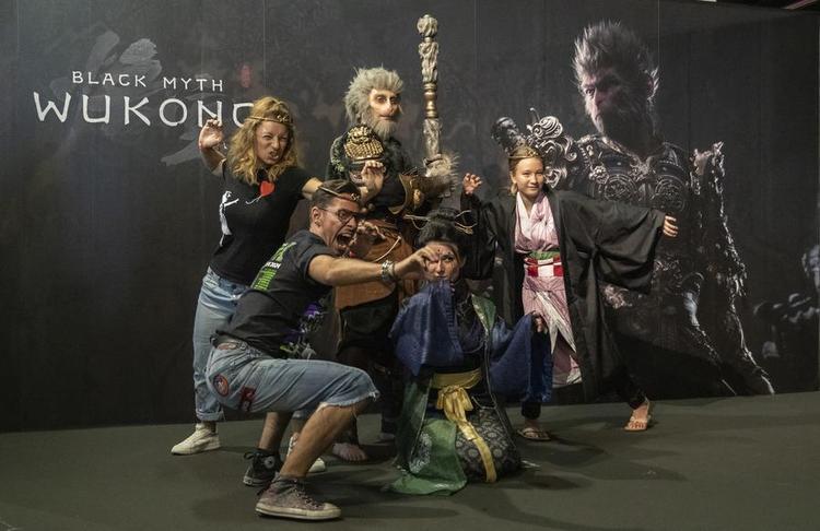 People pose for photos at the photo area of "Black Myth: Wukong" during Gamescom 2024 in Cologne, Germany, on Aug. 22, 2024. (Xinhua/Zhang Fan)