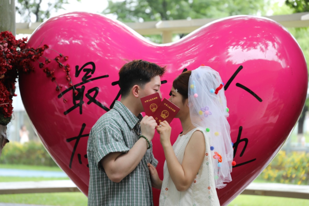 5月20日，天空飘着淅沥小雨，南京 “金陵浪漫中心”婚姻登记处，众多新人冒雨前来领证，画面温馨甜蜜，为雨中的金陵城平添几分浪漫气息。
“520”因谐音“我爱你”，已成为众多适婚青年眼中的“良辰吉日”。 据悉，有超2800对新人选择5月20日这天在南京领证。 
新华日报•交汇点记者 聂伟 通讯员 徐福庚