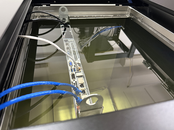 A server sits in a tank of coolant, fully submerged. The liquid cools the hardware more efficiently, cutting down electricity costs while enabling Ready Server to deploy more powerful servers.