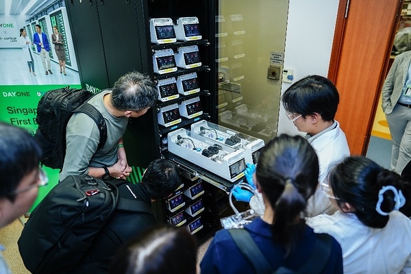 Photo shows guests taking a closer look at the CL1 biological computing system during a live demonstration at the launch event. Photo shows guests taking a closer look at the CL1 biological computing system during a live demonstration at the launch event.